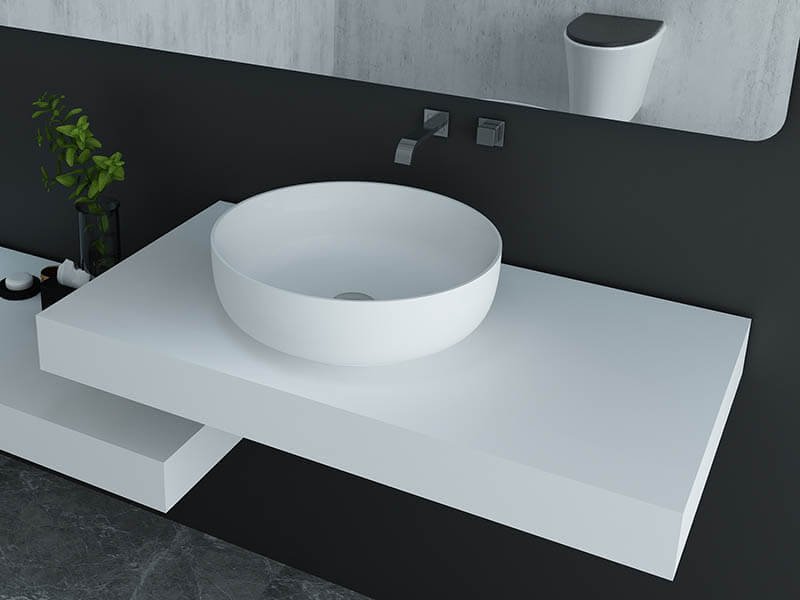 bowl shape wash basin atop solid surface vanitytop